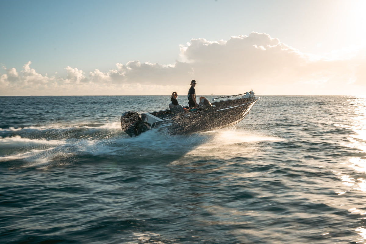 Makocraft tinnie running across open water at sunrise